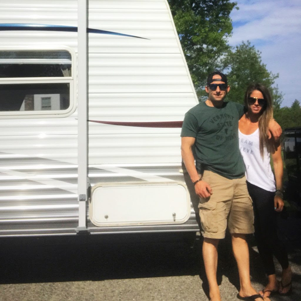 Crystal and Jesse taking a photo near an RV